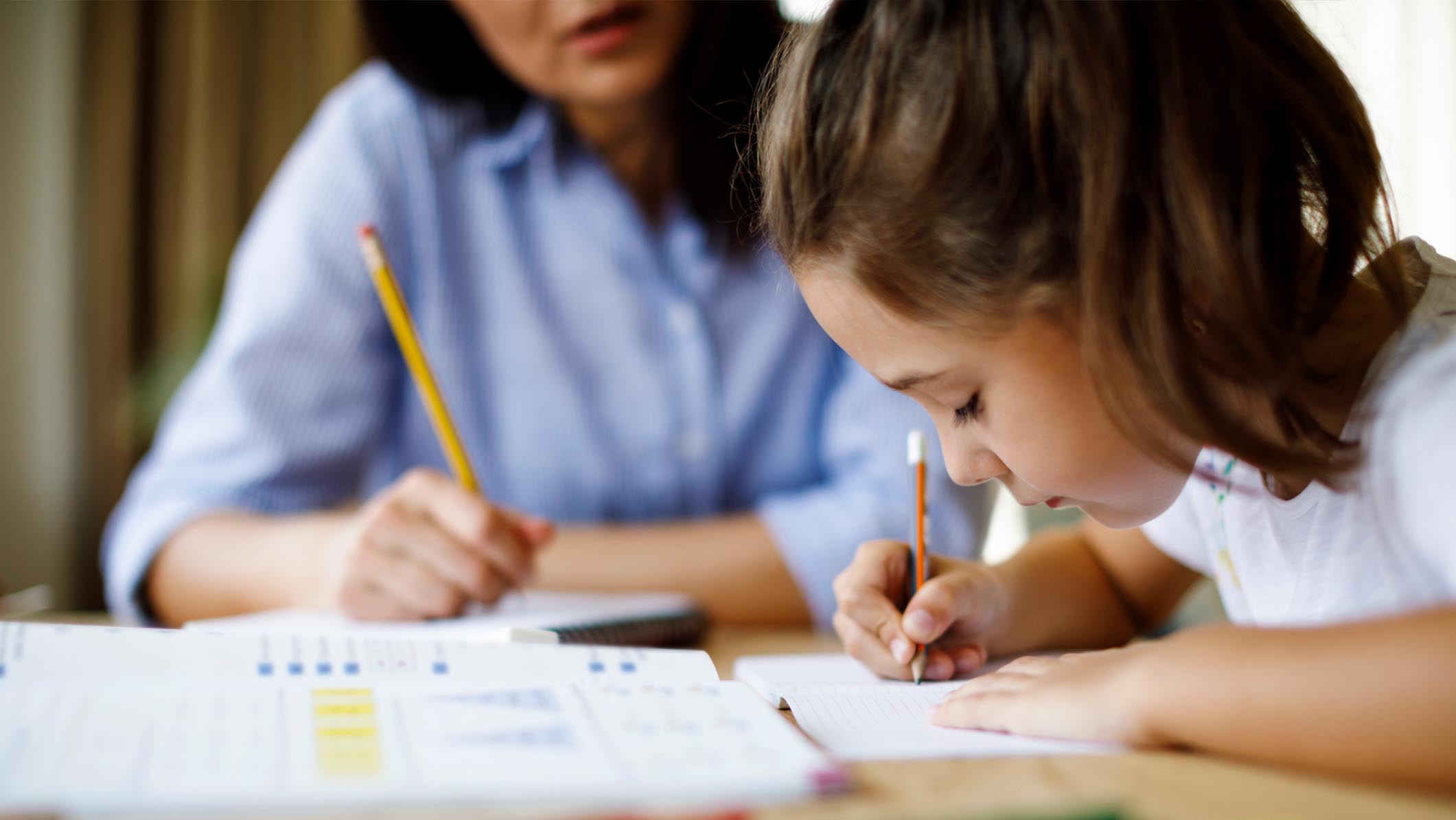 Homeschooling - Mother Helping To Her Daughters To Finish School Homework During Coronavirus Quarantine